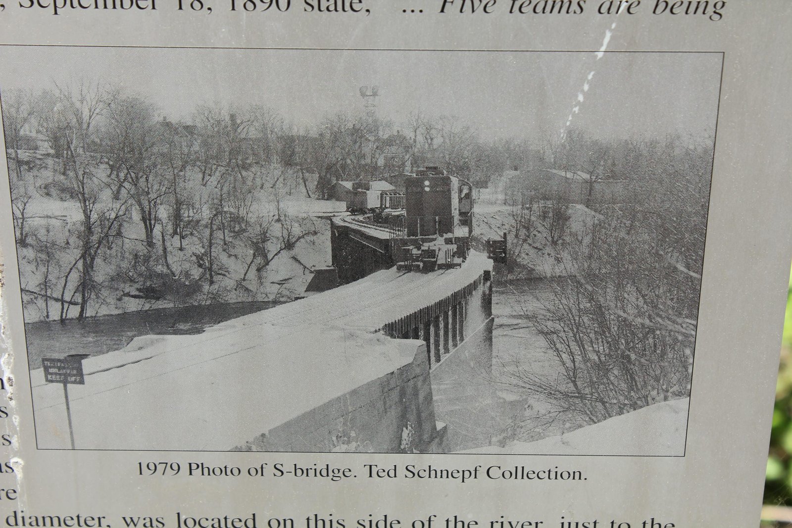 Historic photo of bridge on sign